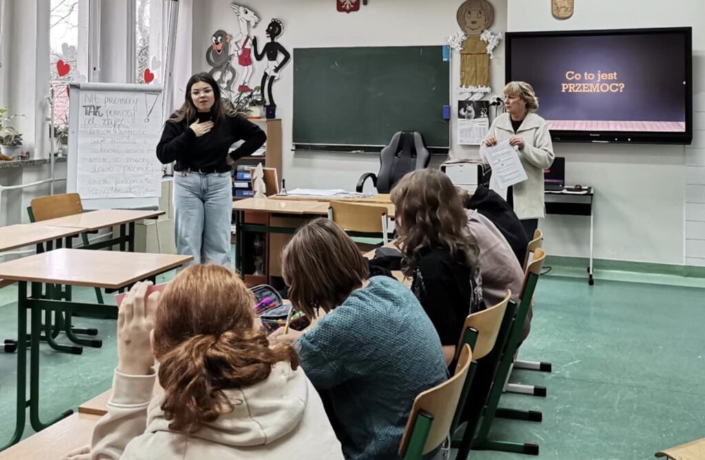 Sala lekcyjna. Prowadzące zajęcia przedstawiają cele  spotkania.